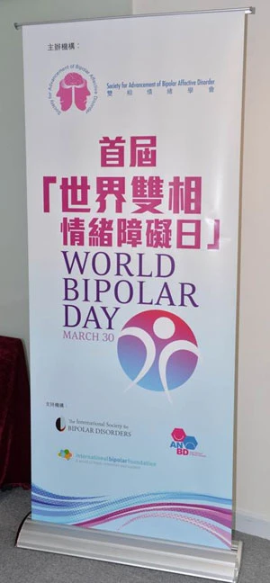 Round white badges with a red-blue logo spread across a dark table at a World Diabetes Day event.