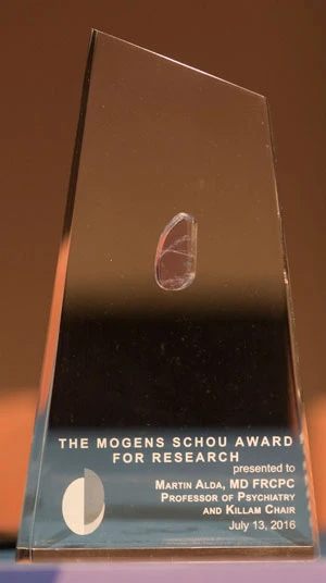Crystal trophy with a small oval detail and an engraved plaque reading: "THE MOGENS SCHOU AWARD FOR RESEARCH" presented to MARTIN ALDA, MD FRCPC, PROFESSOR OF PSYCHIATRY AND KILLAM CHAIR, July 13, 2016.